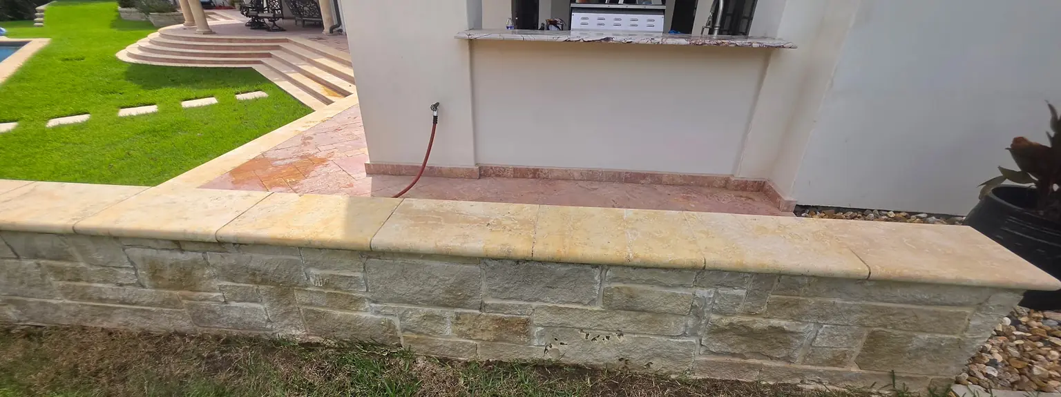 After: the same stone wall cap, clean