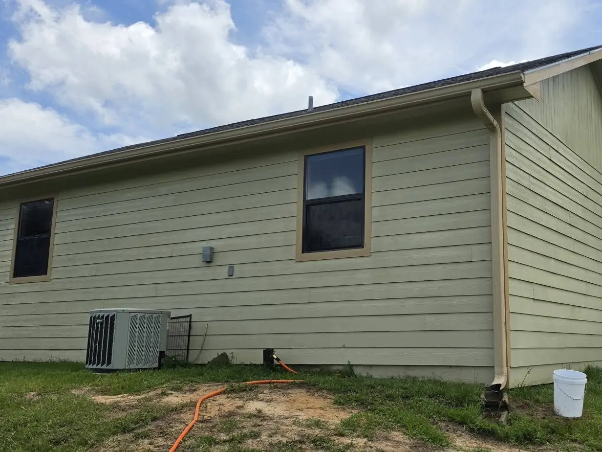 After: the same corner of the building with clean siding