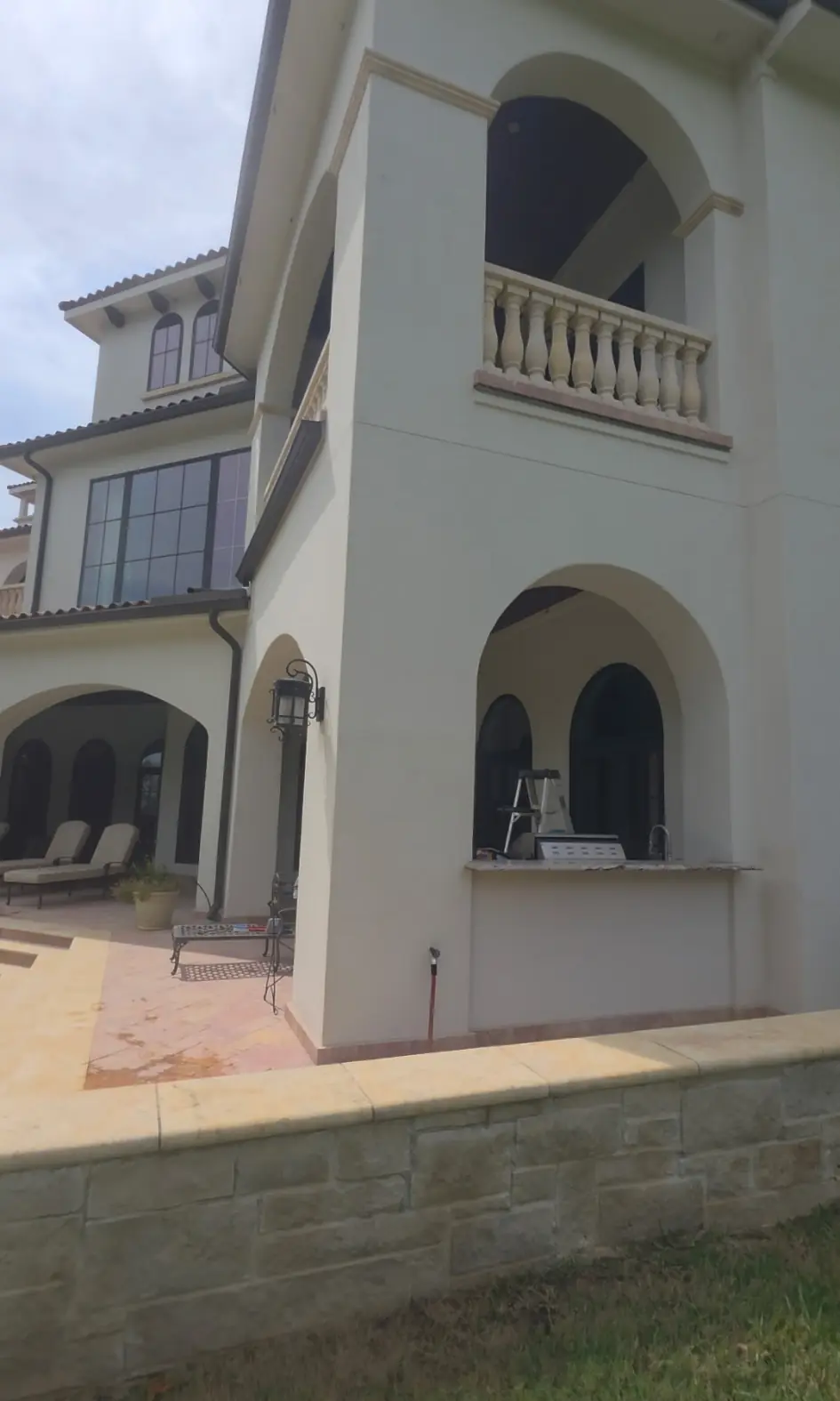 After: the same stucco tower and balcony, clean cream walls