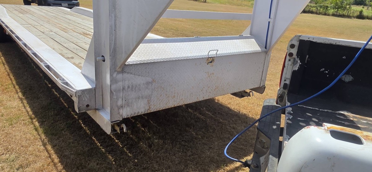 Rust-stained equipment trailer before pressure washing